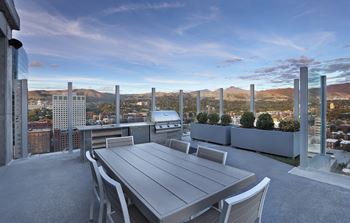 Rooftop terrace with outdoor dining and grill
